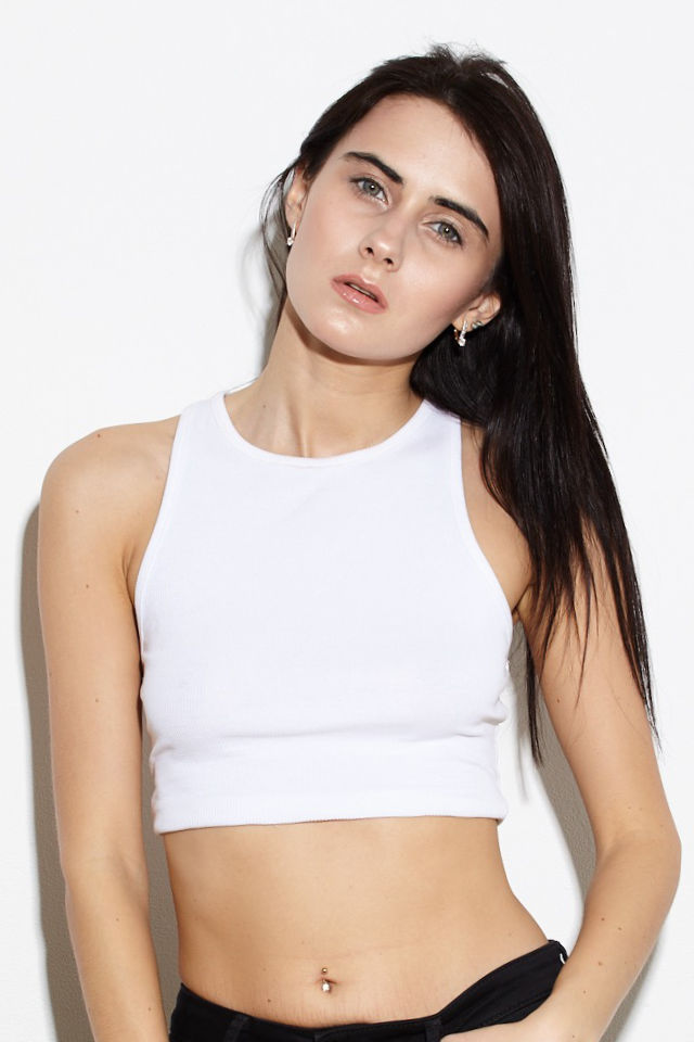 Studio mood portrait of fashion model Lera full body against white wall