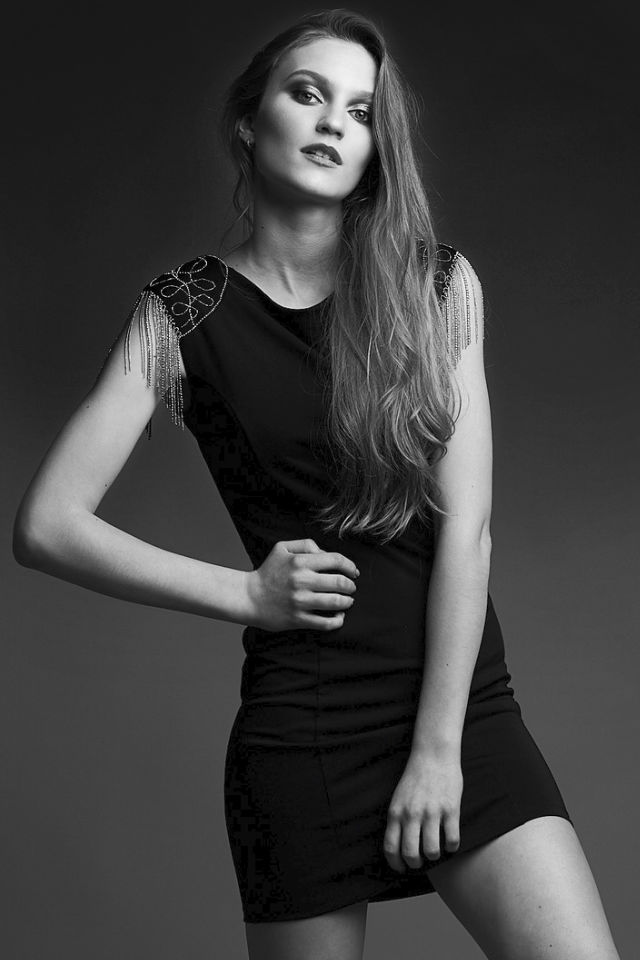 Nastya studio portrait. Confident post, short black dress
