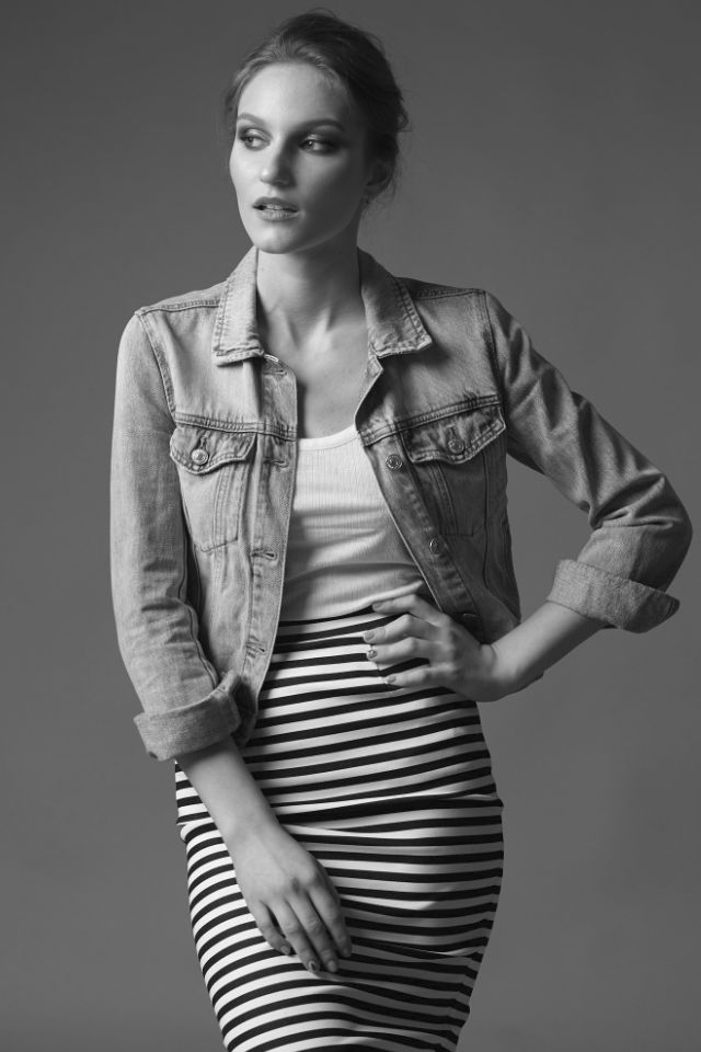 Nastya studio portrait. Short skirt, tank top shirt and a jeans jacket.
