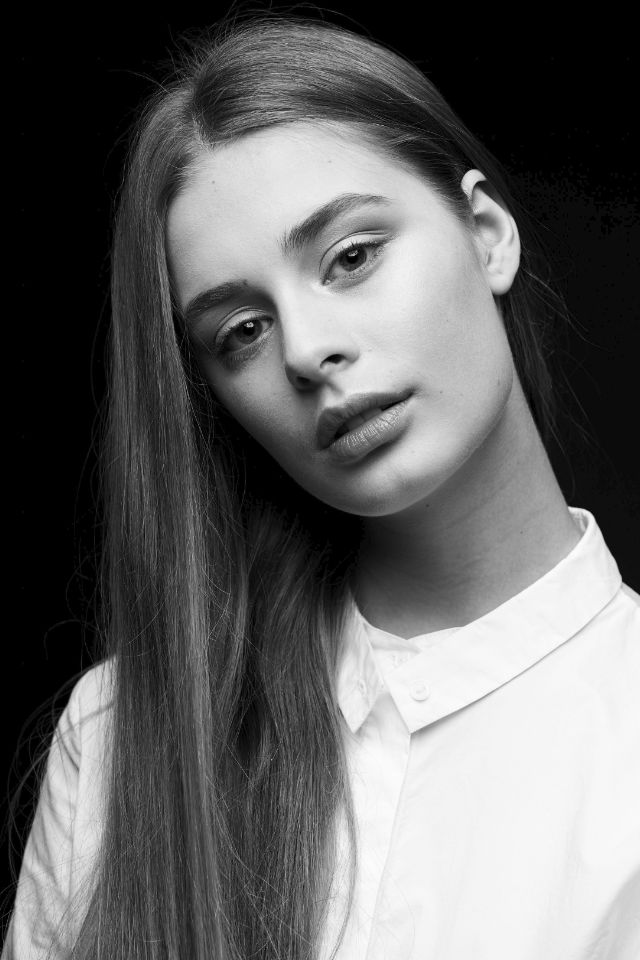 Sasha single light portrait. Dark background, light clothes.